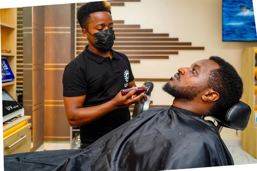 Barber trimming a client's beard at Lintons
