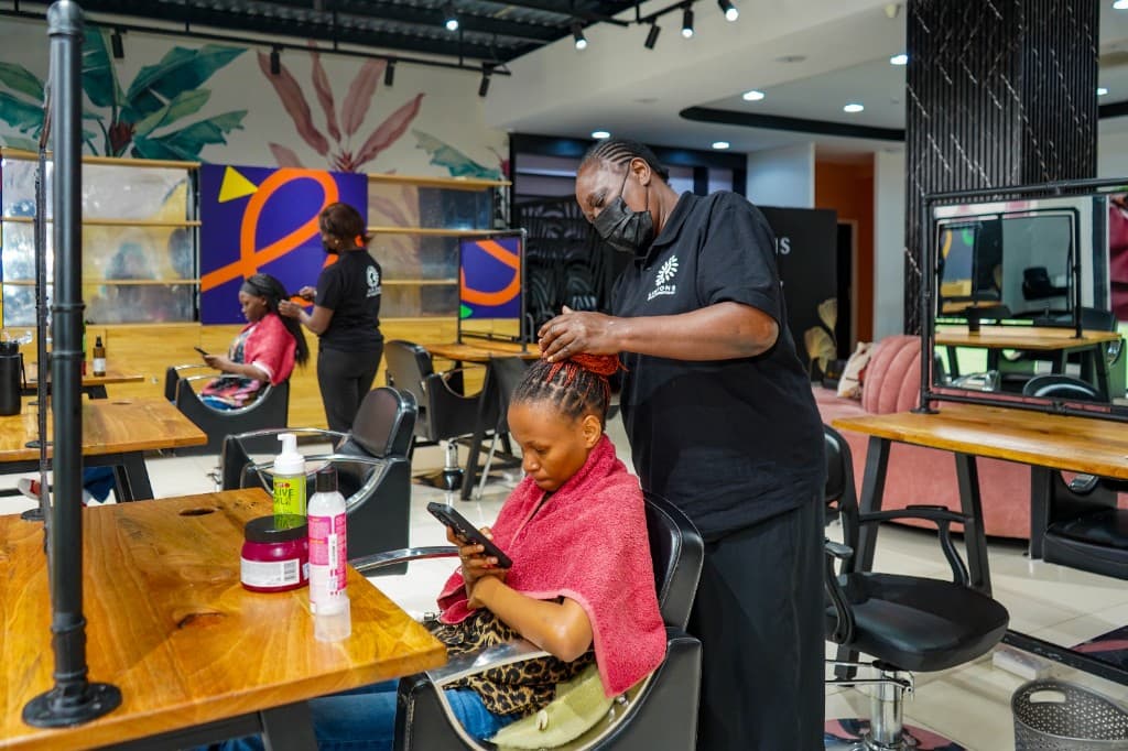 Stylist braiding client hair at Lintons Spa and Hair Studio